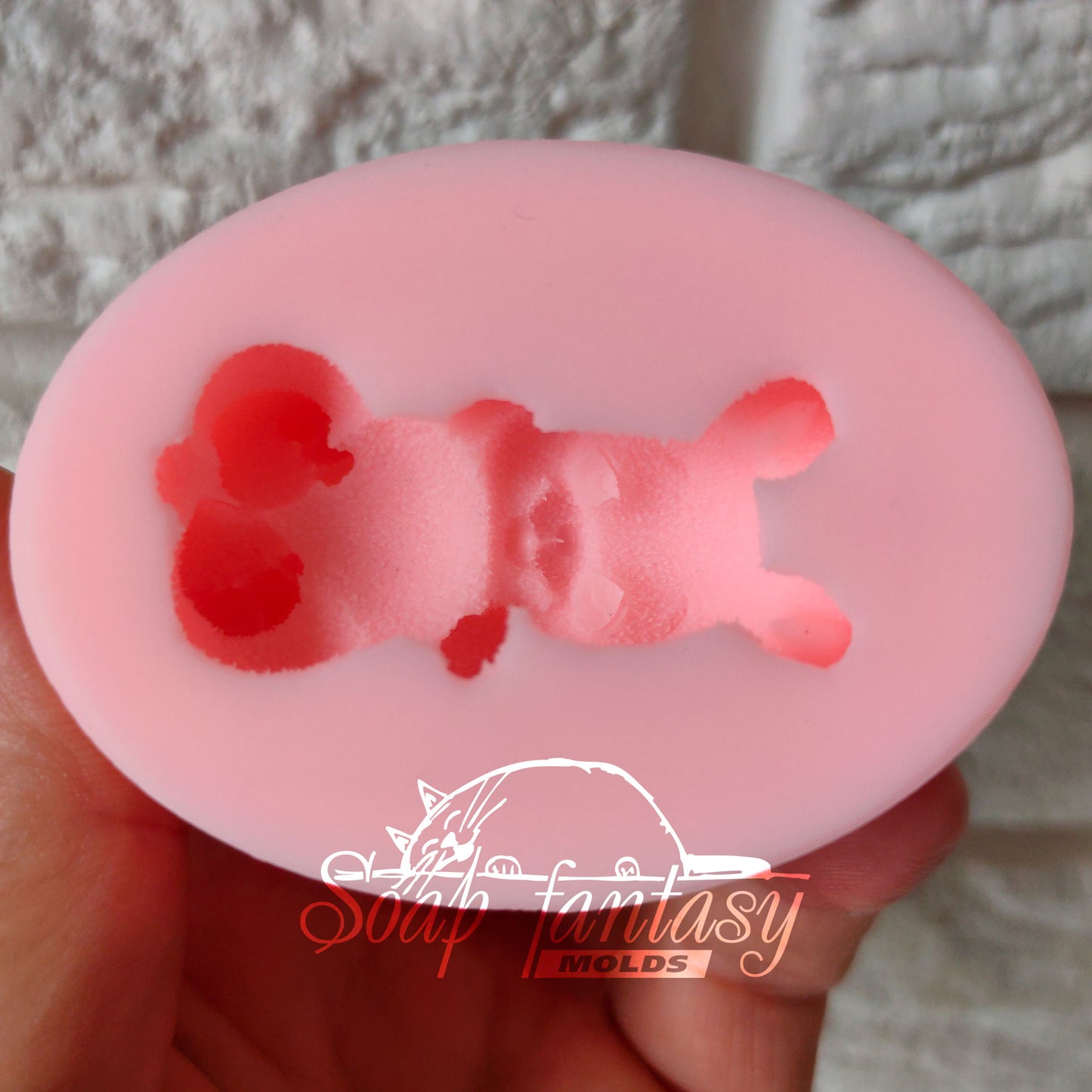 The bunny lies on the back silicone mold for soap making
